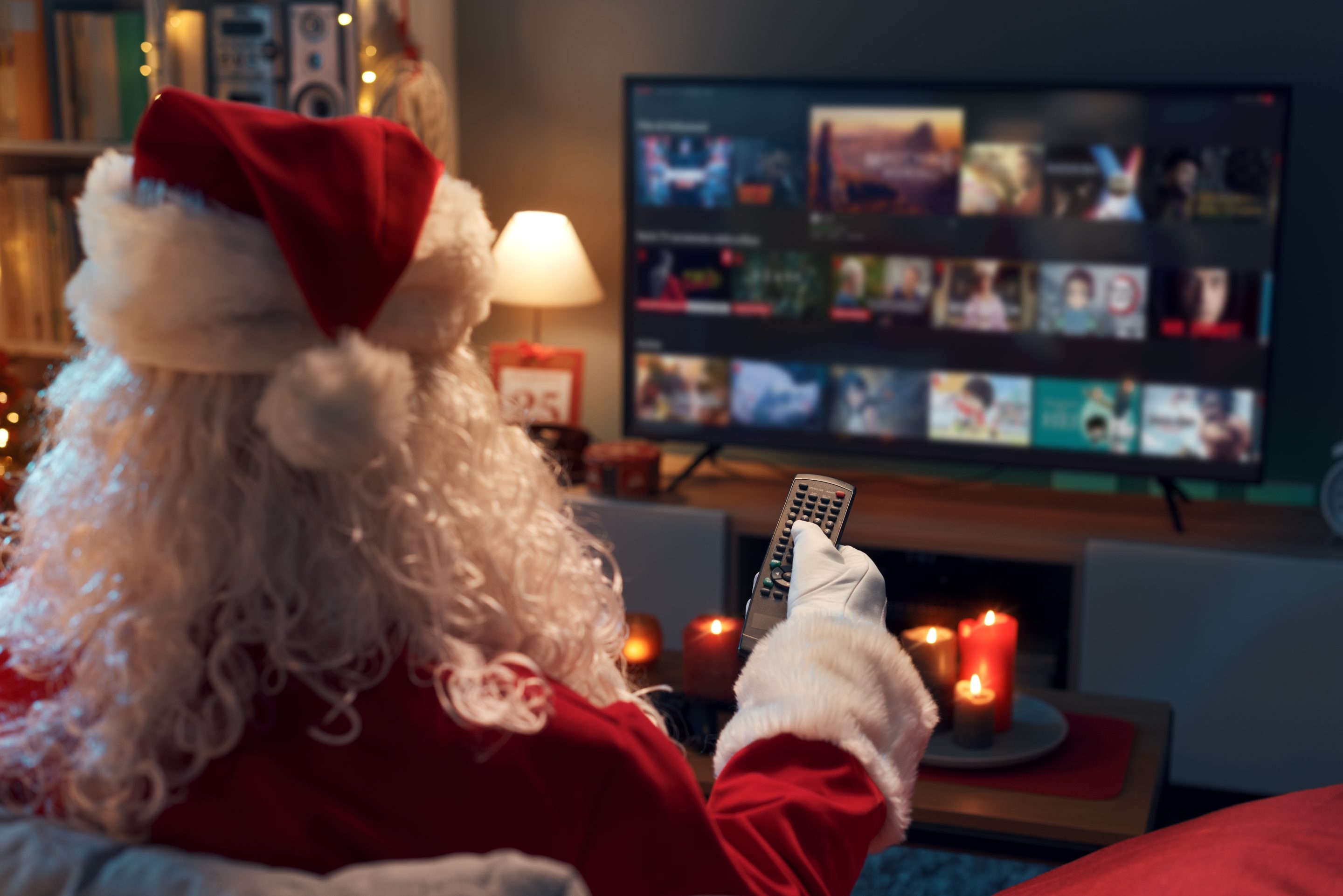 Santa,Claus,Relaxing,On,The,Couch,At,Home,And,Watching
